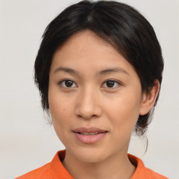 Joyful asian young-adult female with medium  brown hair and brown eyes