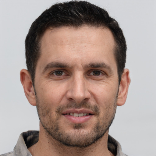 Joyful white adult male with short  brown hair and brown eyes