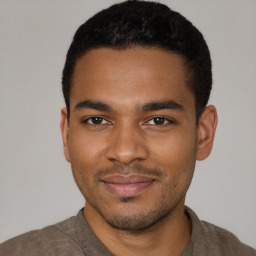 Joyful black young-adult male with short  brown hair and brown eyes