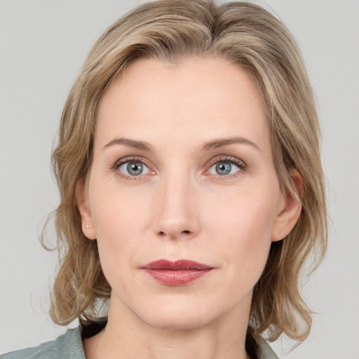 Joyful white young-adult female with medium  brown hair and blue eyes