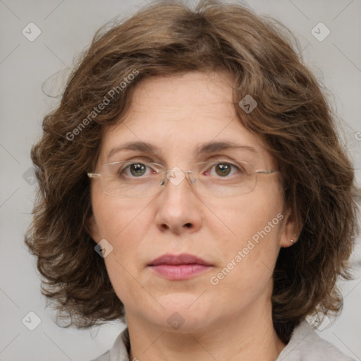 Joyful white adult female with medium  brown hair and green eyes