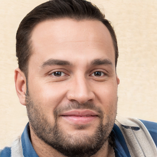 Joyful white adult male with short  brown hair and brown eyes