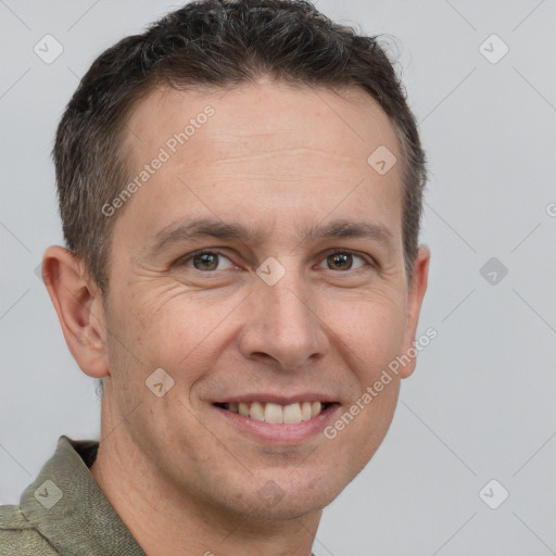 Joyful white adult male with short  brown hair and brown eyes