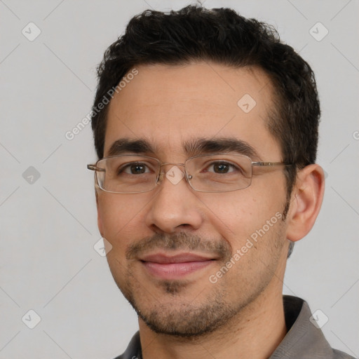 Joyful white adult male with short  black hair and brown eyes