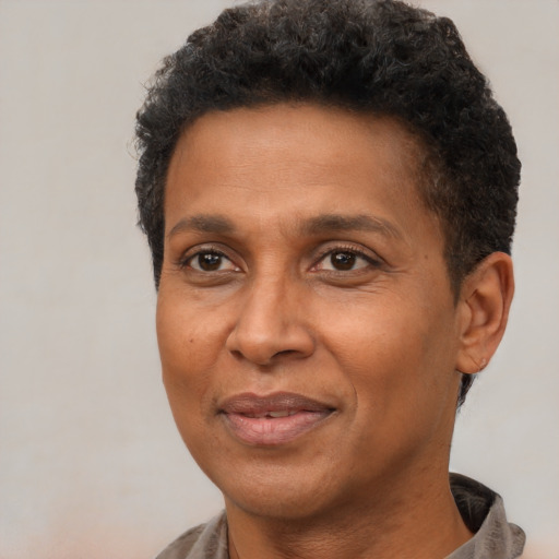 Joyful black adult male with short  brown hair and brown eyes