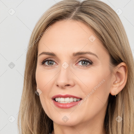 Joyful white adult female with long  brown hair and brown eyes