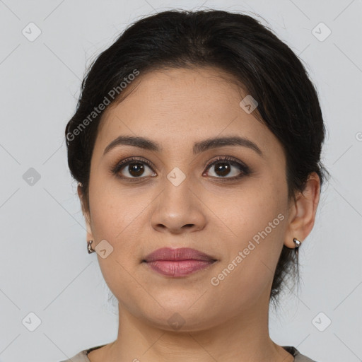 Joyful latino young-adult female with medium  brown hair and brown eyes