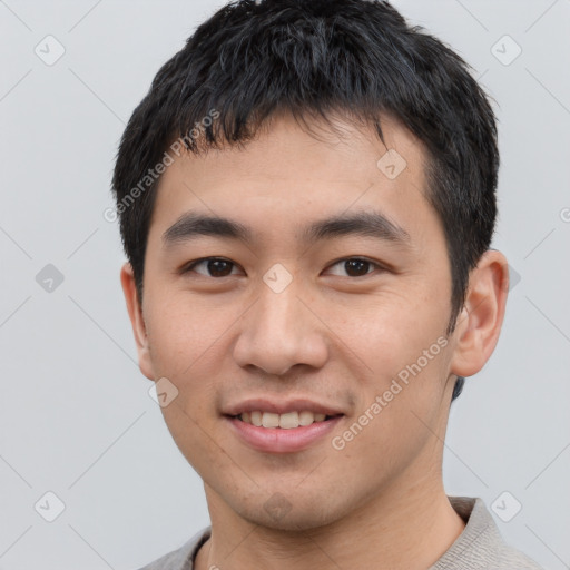 Joyful asian young-adult male with short  black hair and brown eyes