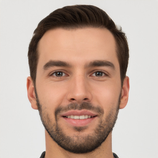 Joyful white young-adult male with short  brown hair and brown eyes