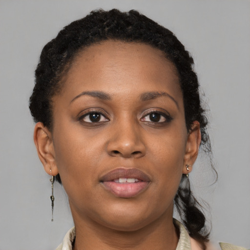 Joyful black young-adult female with medium  brown hair and brown eyes