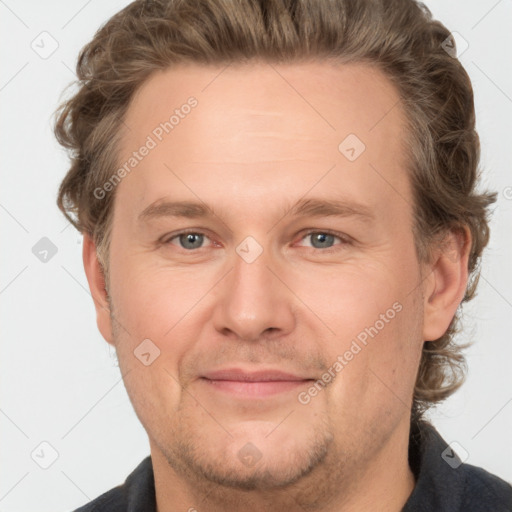 Joyful white adult male with short  brown hair and grey eyes