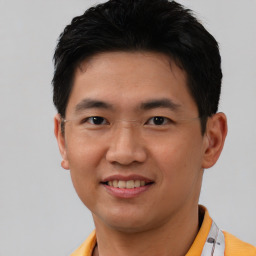 Joyful asian young-adult male with short  brown hair and brown eyes