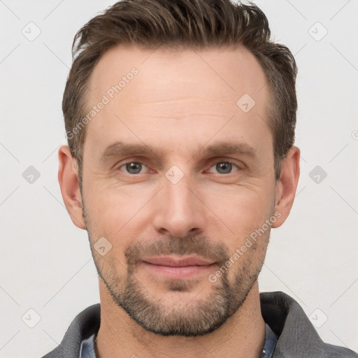 Joyful white adult male with short  brown hair and grey eyes