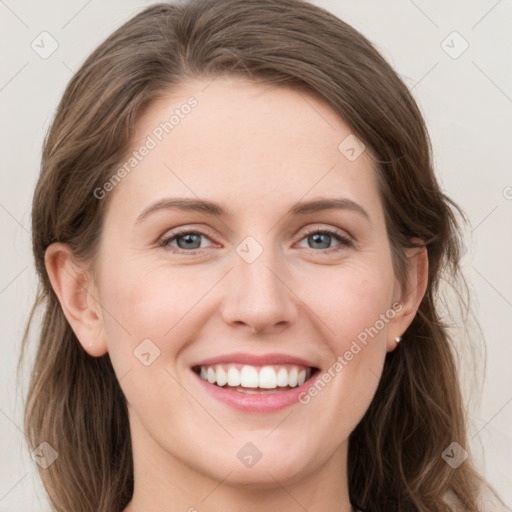 Joyful white young-adult female with long  brown hair and grey eyes