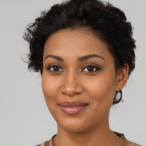 Joyful latino young-adult female with short  brown hair and brown eyes