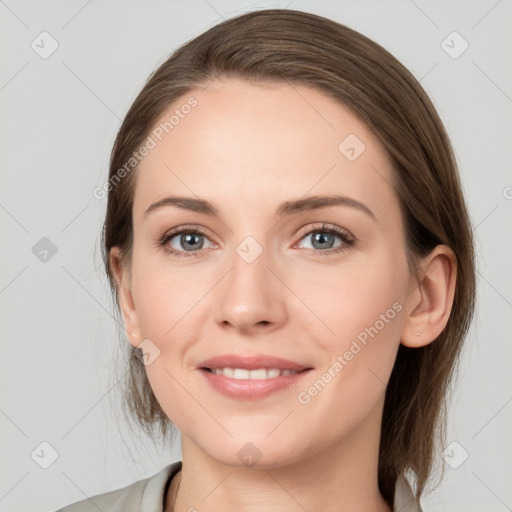 Joyful white young-adult female with medium  brown hair and grey eyes