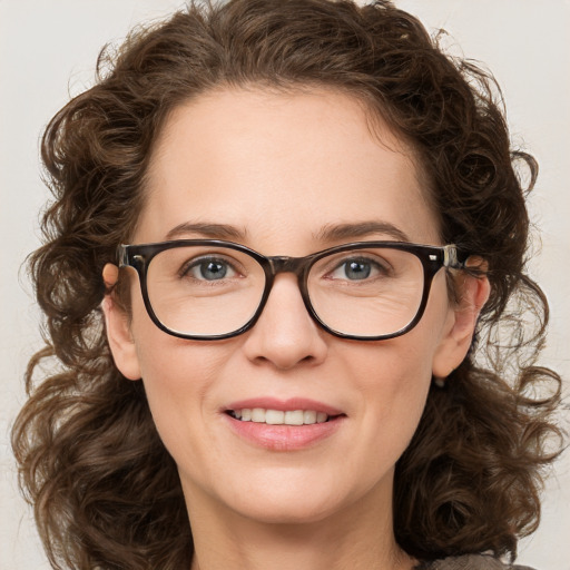 Joyful white young-adult female with medium  brown hair and green eyes