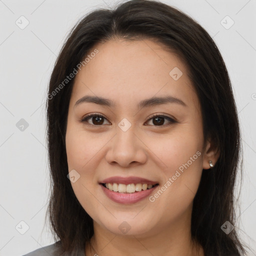 Joyful white young-adult female with long  brown hair and brown eyes