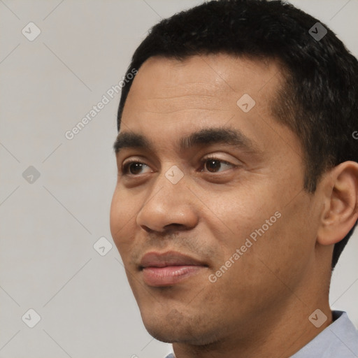 Joyful white young-adult male with short  black hair and brown eyes