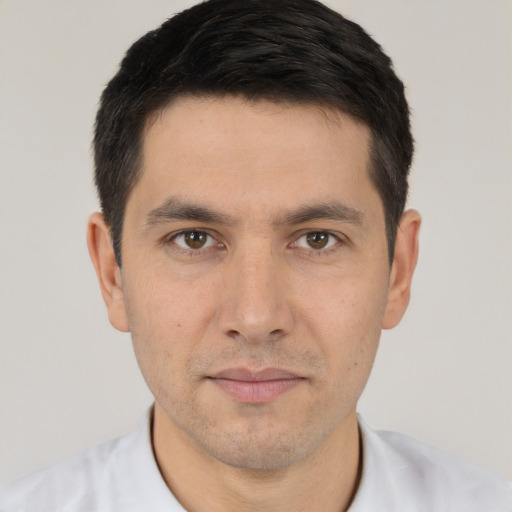 Joyful white young-adult male with short  black hair and brown eyes