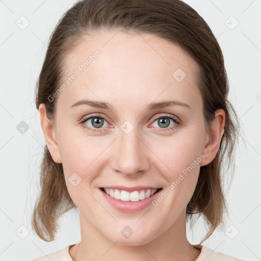 Joyful white young-adult female with medium  brown hair and blue eyes