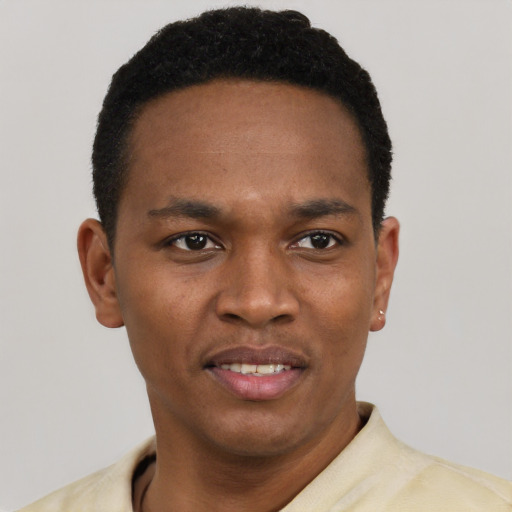 Joyful black young-adult male with short  black hair and brown eyes