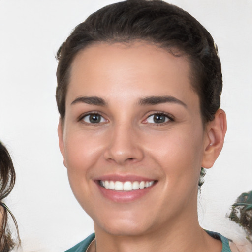 Joyful white young-adult female with medium  brown hair and brown eyes