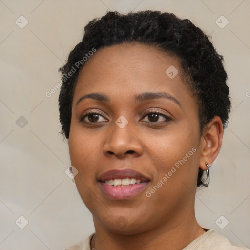 Joyful black young-adult female with short  black hair and brown eyes