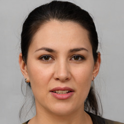 Joyful white adult female with medium  brown hair and brown eyes