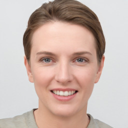 Joyful white young-adult female with short  brown hair and grey eyes