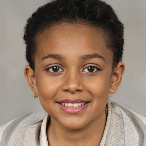 Joyful black child female with short  brown hair and brown eyes