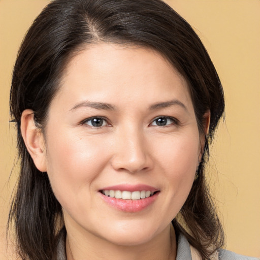 Joyful white young-adult female with medium  brown hair and brown eyes