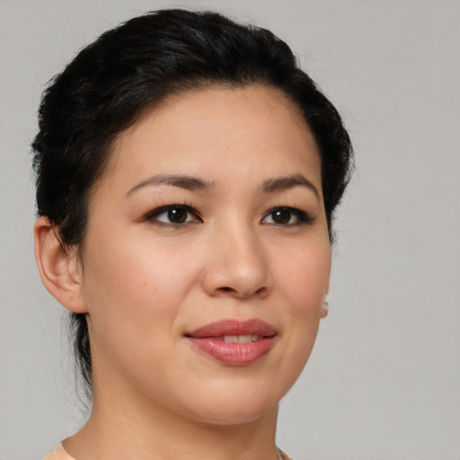 Joyful asian young-adult female with short  brown hair and brown eyes