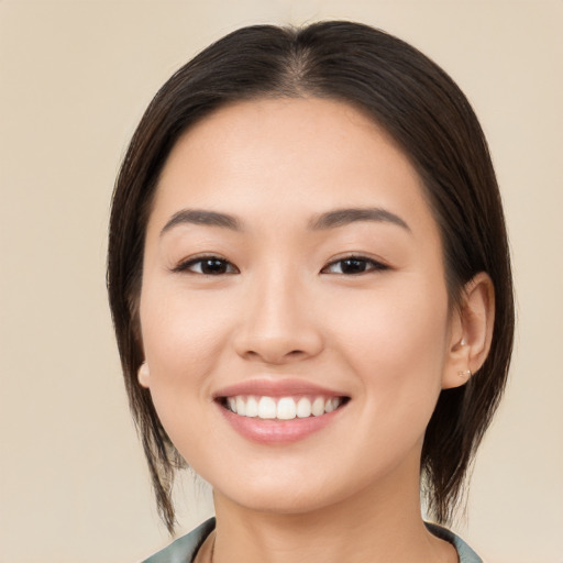 Joyful white young-adult female with medium  brown hair and brown eyes