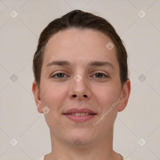 Joyful white young-adult female with short  brown hair and grey eyes