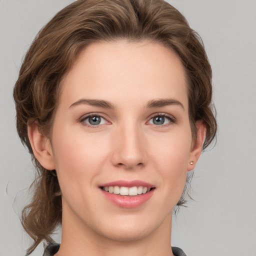 Joyful white young-adult female with medium  brown hair and grey eyes