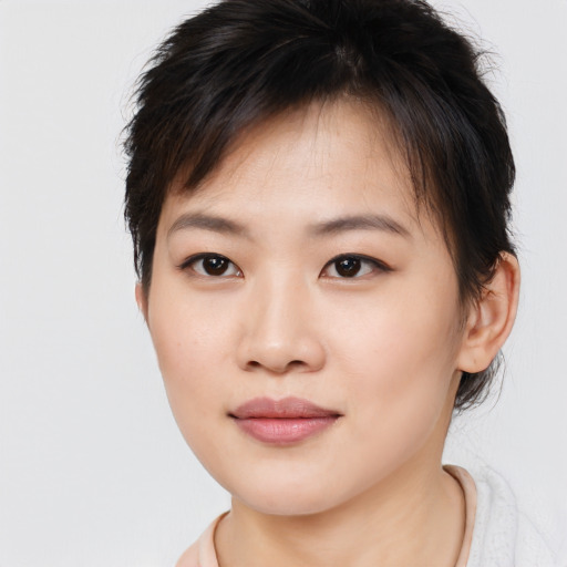 Joyful asian young-adult female with short  brown hair and brown eyes
