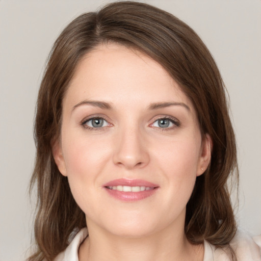 Joyful white young-adult female with medium  brown hair and blue eyes