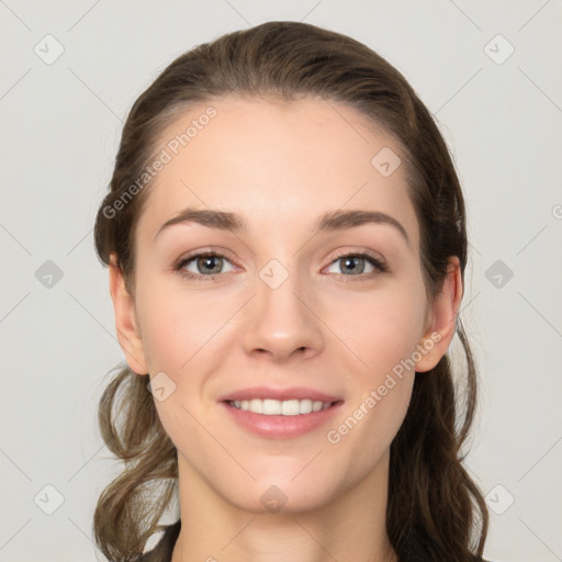 Joyful white young-adult female with long  brown hair and grey eyes