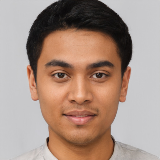 Joyful latino young-adult male with short  black hair and brown eyes