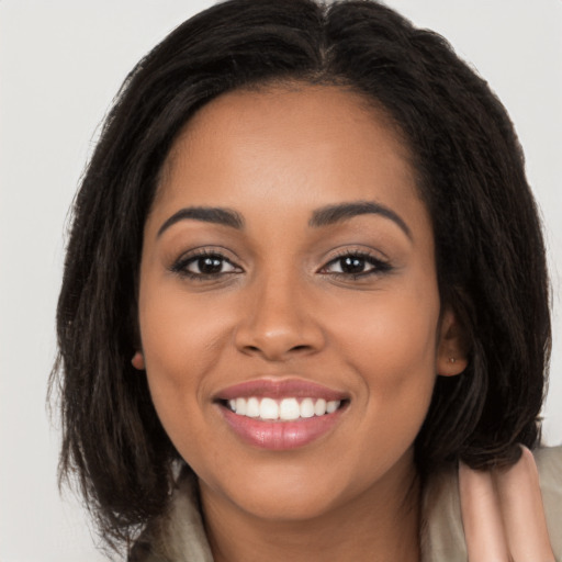 Joyful latino young-adult female with long  brown hair and brown eyes