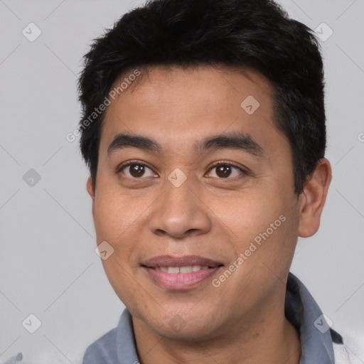 Joyful asian young-adult male with short  black hair and brown eyes