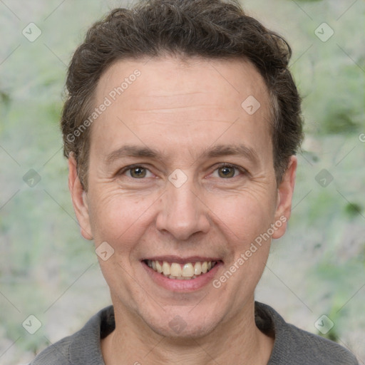 Joyful white adult male with short  brown hair and grey eyes