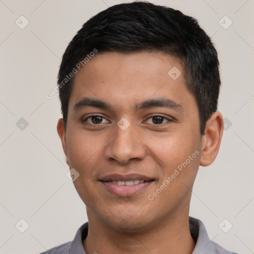 Joyful latino young-adult male with short  black hair and brown eyes