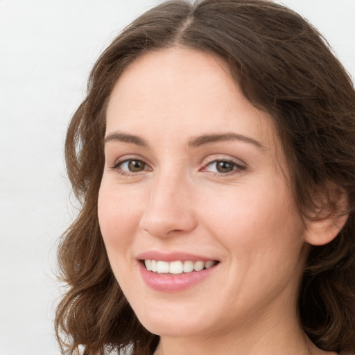 Joyful white young-adult female with long  brown hair and green eyes