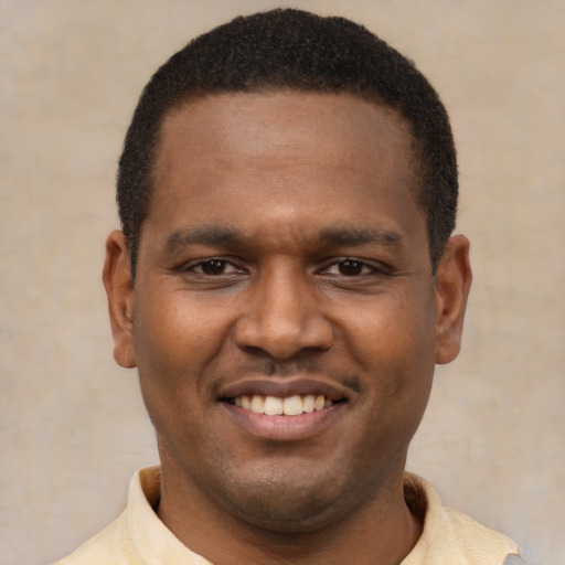 Joyful latino young-adult male with short  brown hair and brown eyes