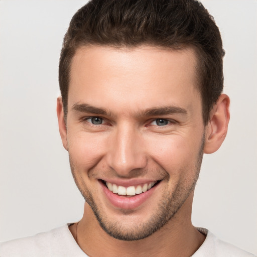 Joyful white young-adult male with short  brown hair and brown eyes