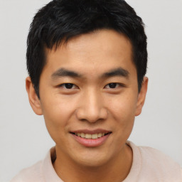 Joyful asian young-adult male with short  black hair and brown eyes