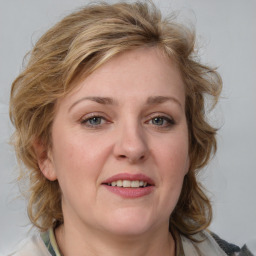 Joyful white young-adult female with medium  brown hair and blue eyes