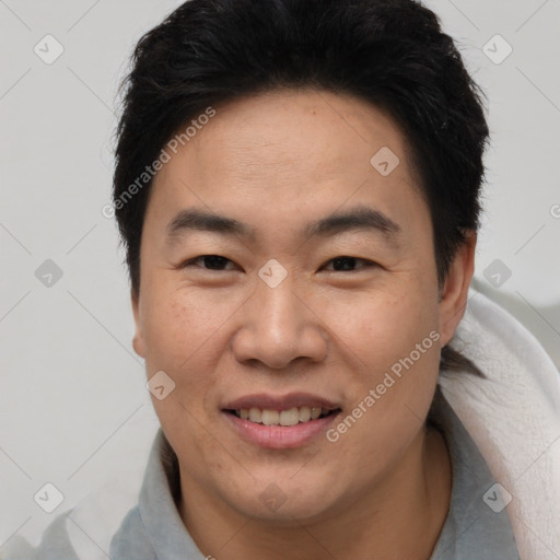 Joyful asian young-adult male with short  brown hair and brown eyes